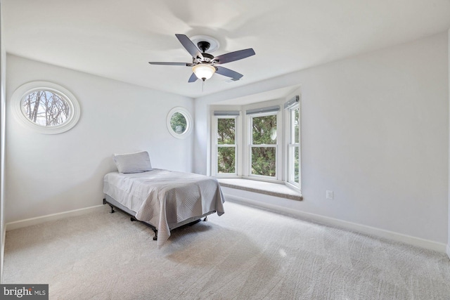 carpeted bedroom with baseboards and ceiling fan