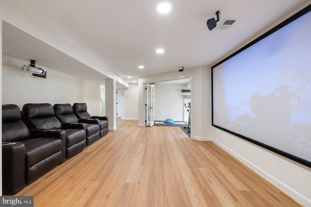 home theater with baseboards, recessed lighting, visible vents, and light wood-type flooring