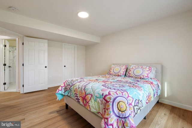 bedroom with baseboards and wood finished floors