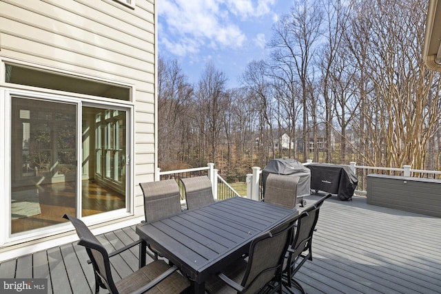 deck with area for grilling and outdoor dining area