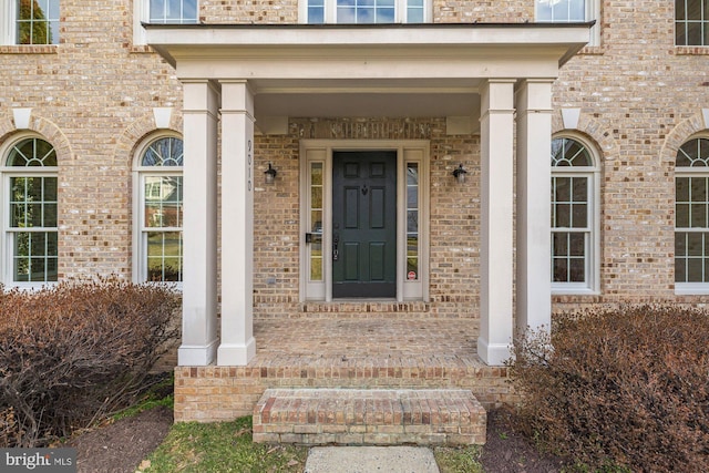 doorway to property with brick siding