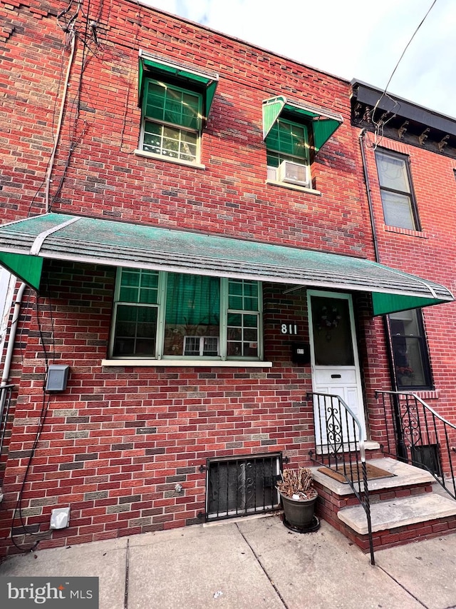 townhome / multi-family property with brick siding