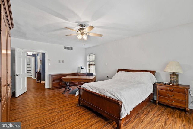 bedroom featuring dark wood-style flooring, visible vents, and a ceiling fan