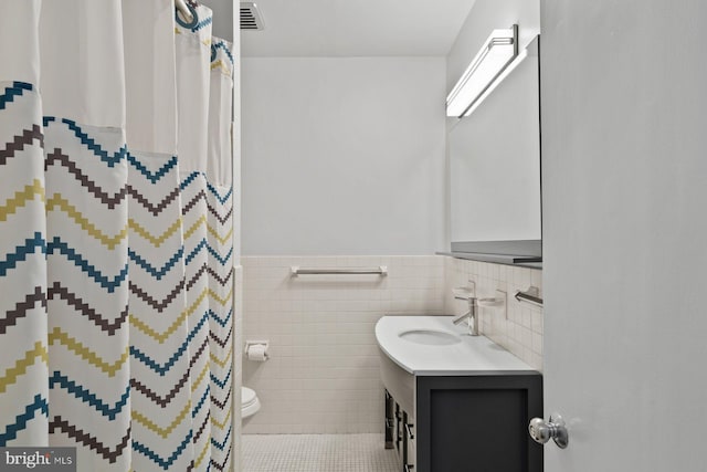 full bath featuring visible vents, toilet, a wainscoted wall, tile patterned flooring, and vanity