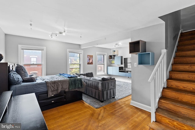 bedroom featuring wood finished floors and baseboards