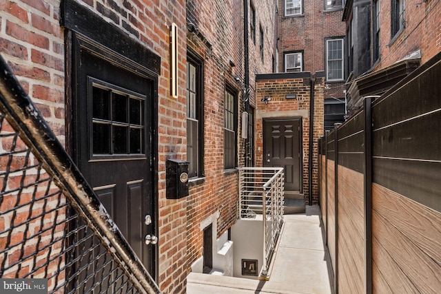 view of exterior entry featuring brick siding