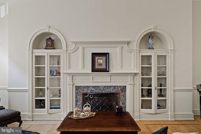 living room featuring light wood finished floors and a premium fireplace