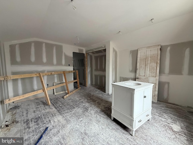 kitchen featuring white cabinetry and a sink