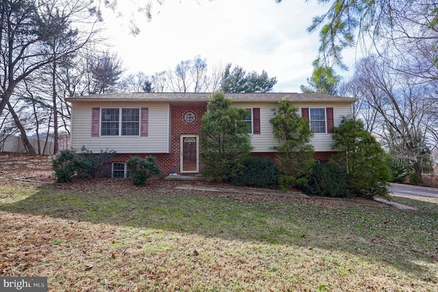 bi-level home featuring brick siding