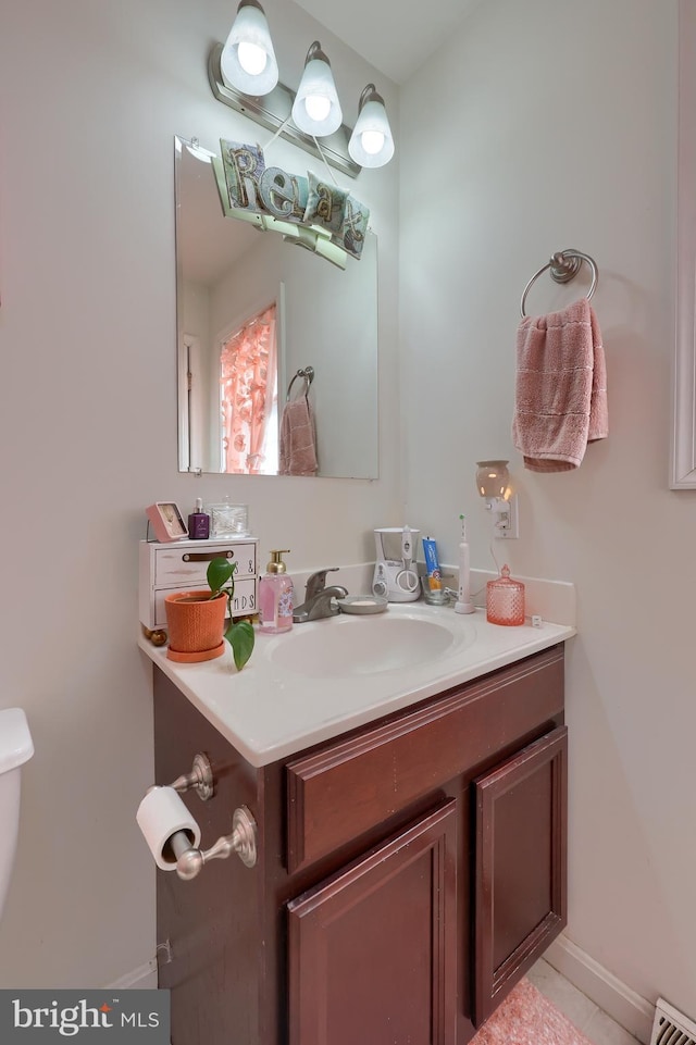 bathroom with visible vents, toilet, and vanity