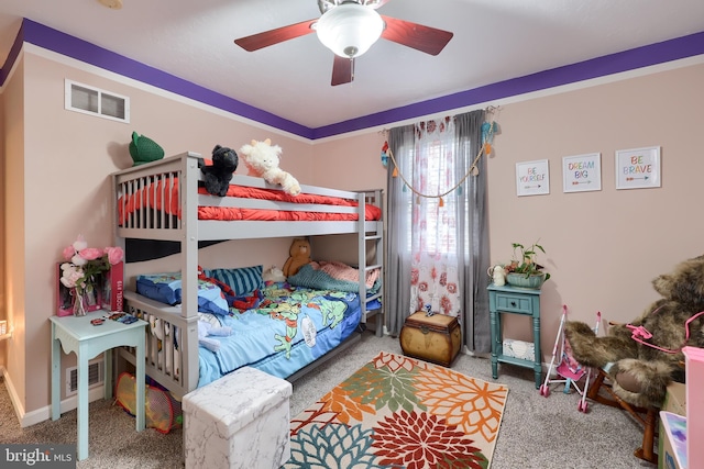 carpeted bedroom featuring visible vents, baseboards, and a ceiling fan