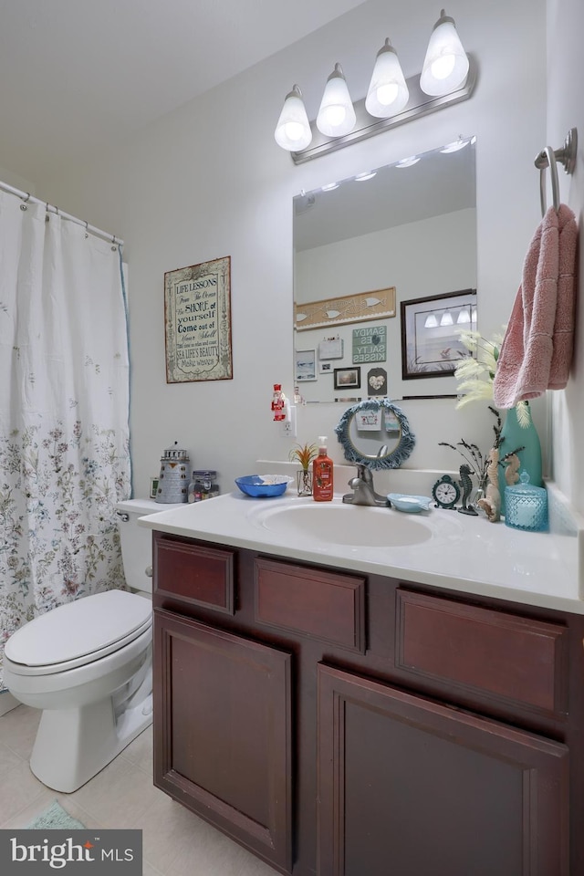 bathroom featuring tile patterned floors, toilet, vanity, and a shower with curtain