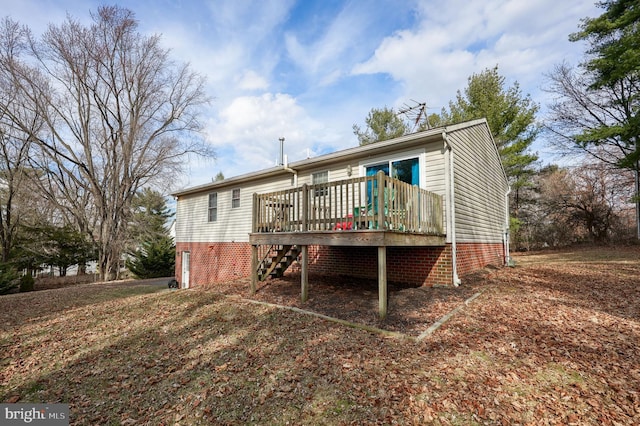 rear view of house featuring stairway and a deck