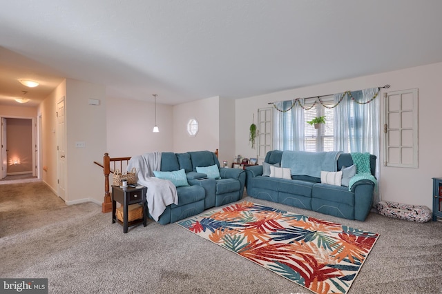 living area featuring baseboards and carpet floors