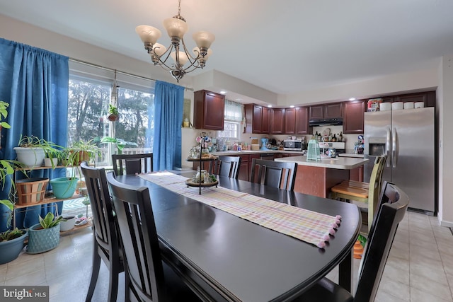 dining room featuring a notable chandelier and light tile patterned floors