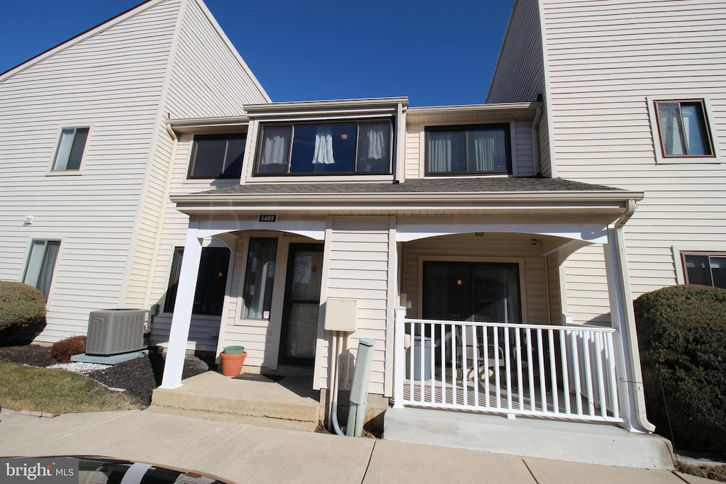 townhome / multi-family property featuring covered porch and central AC