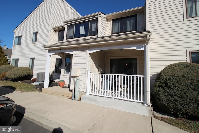 view of front of home featuring covered porch and cooling unit