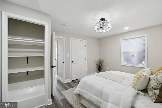 bedroom featuring dark wood-type flooring and baseboards