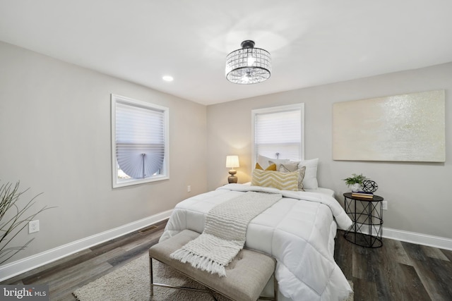 bedroom with recessed lighting, wood finished floors, visible vents, and baseboards