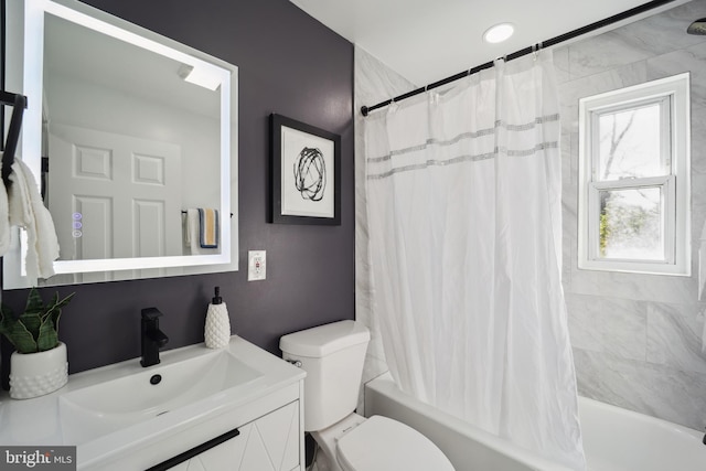 bathroom featuring shower / tub combo, vanity, and toilet