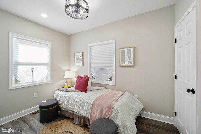 bedroom with baseboards, wood finished floors, and recessed lighting