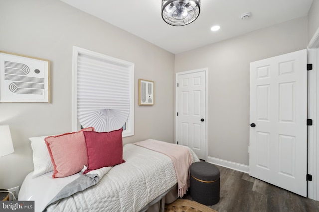 bedroom with wood finished floors and baseboards