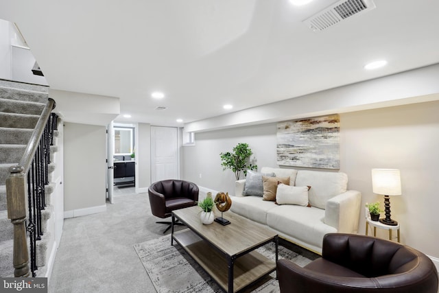 living area with recessed lighting, stairs, visible vents, and light colored carpet