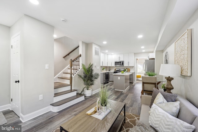 living area featuring wine cooler, recessed lighting, visible vents, stairs, and dark wood finished floors