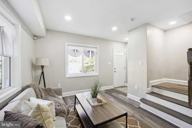 living room with stairs, recessed lighting, wood finished floors, and baseboards