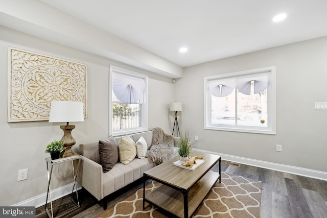 living room with baseboards, wood finished floors, and recessed lighting