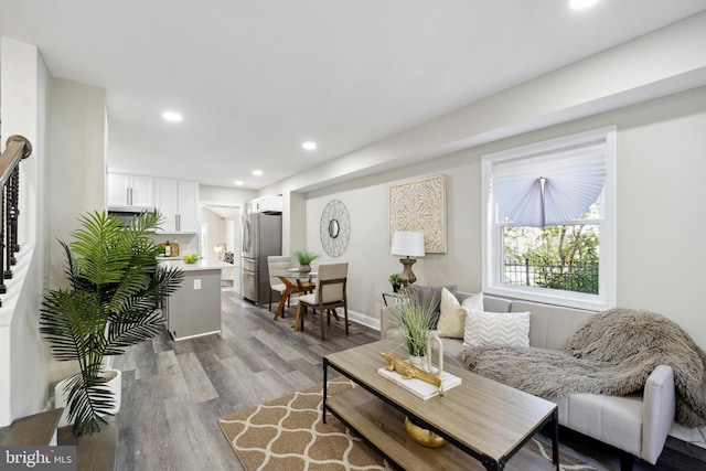 living room featuring baseboards, wood finished floors, and recessed lighting