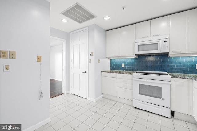 kitchen with white appliances, backsplash, visible vents, and white cabinets