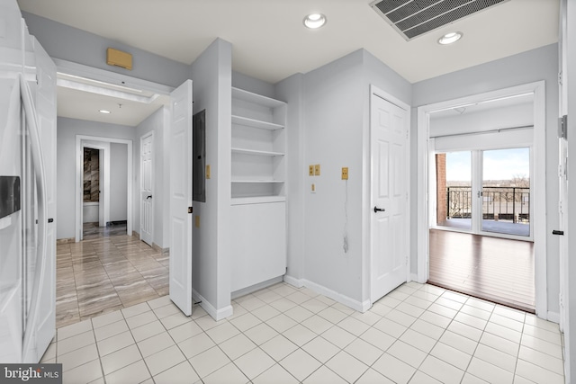 interior space with built in shelves, light tile patterned floors, recessed lighting, visible vents, and baseboards