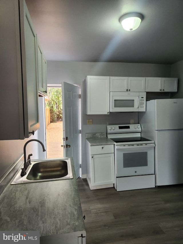 kitchen featuring dark wood-style floors, white appliances, a sink, and white cabinets