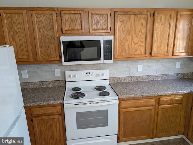 kitchen featuring tasteful backsplash, white appliances, and brown cabinetry