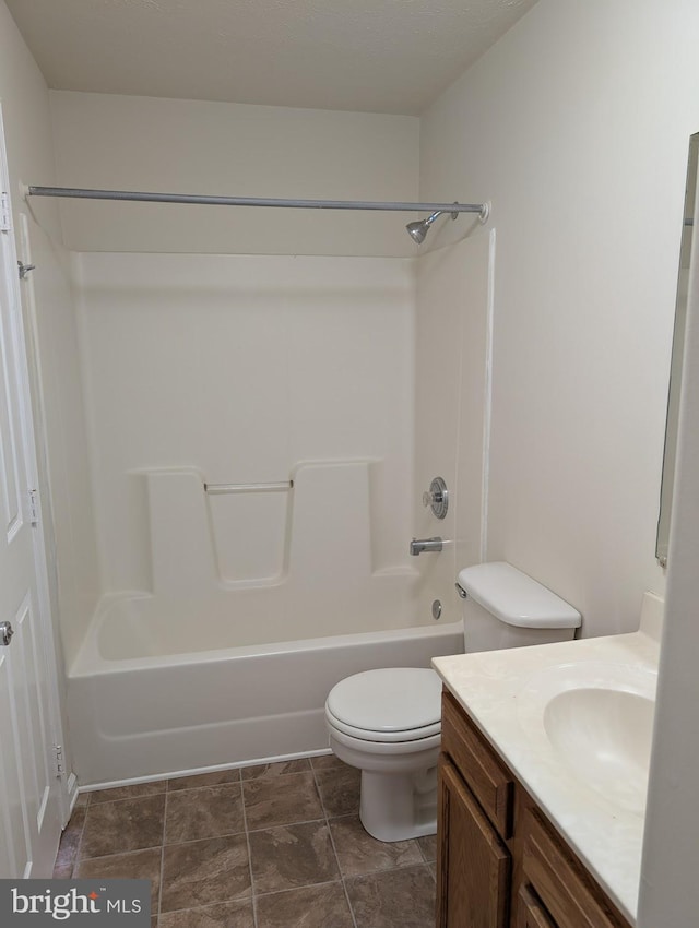 bathroom with toilet, shower / bathing tub combination, and vanity