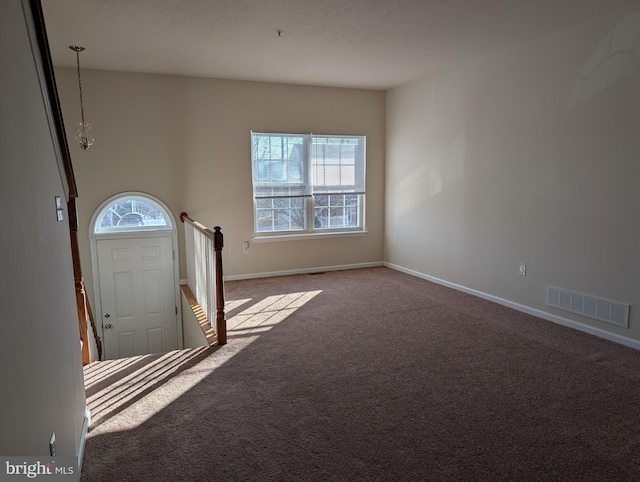 interior space with a healthy amount of sunlight, visible vents, and baseboards