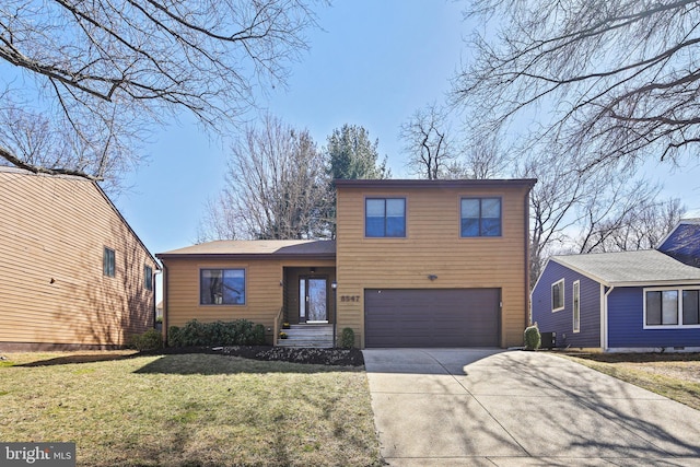 view of front of home with a front lawn, a garage, and driveway