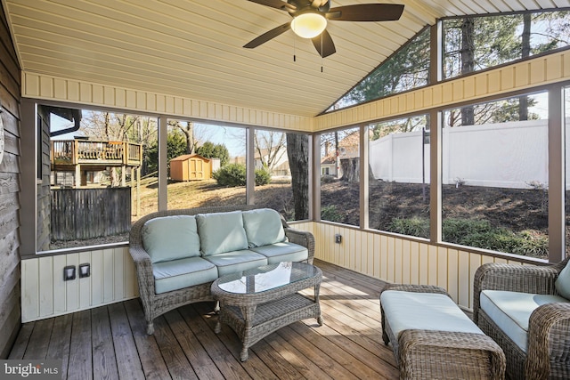 sunroom featuring ceiling fan and vaulted ceiling