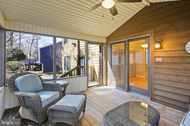 sunroom featuring vaulted ceiling and ceiling fan