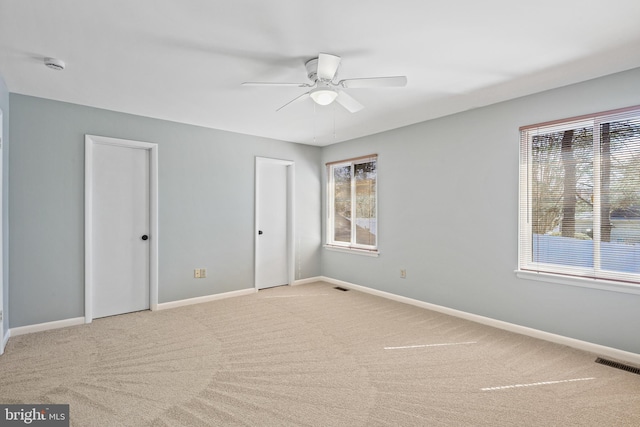 interior space featuring visible vents, ceiling fan, baseboards, and carpet