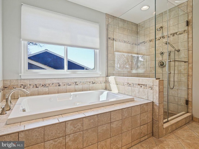 bathroom with tile patterned floors, a stall shower, and a bath