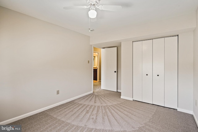 unfurnished bedroom featuring a closet, carpet flooring, a ceiling fan, and baseboards