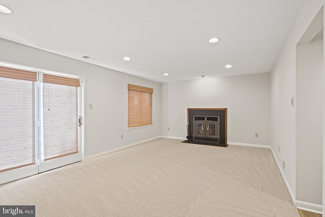 unfurnished living room featuring recessed lighting, baseboards, and carpet floors