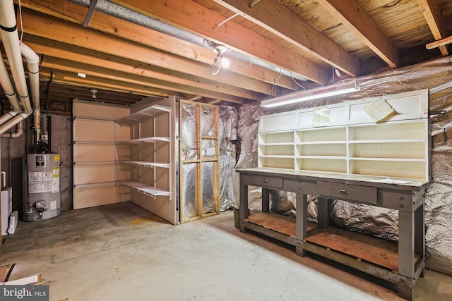 unfinished basement featuring gas water heater