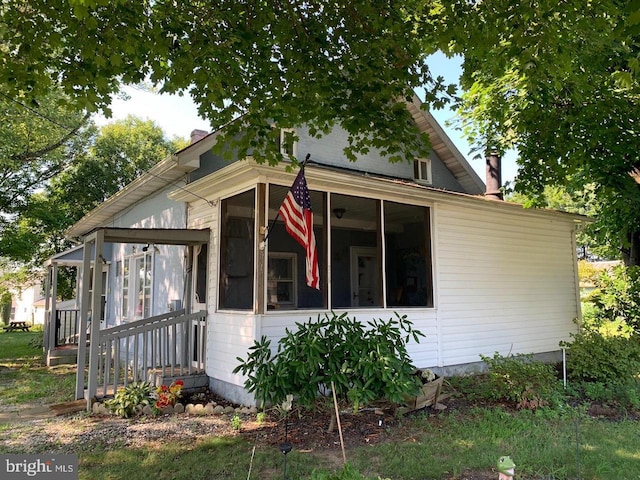 view of side of home featuring a sunroom