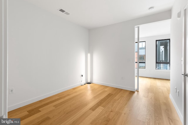 7175 12th St NW Unit 601, Washington, DC 20011 - unfurnished room featuring baseboards, visible vents, and light wood-style floors