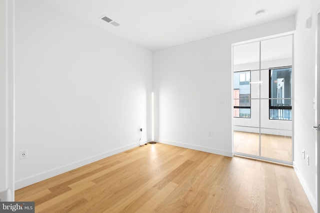 7175 12th St NW Unit 601, Washington, DC 20011 - empty room featuring visible vents, light wood-style flooring, and baseboards