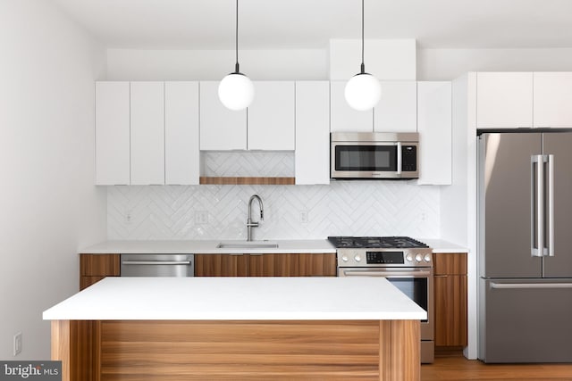 7175 12th St NW Unit 601, Washington, DC 20011 - kitchen featuring backsplash, a sink, appliances with stainless steel finishes, and modern cabinets