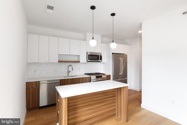 7175 12th St NW Unit 601, Washington, DC 20011 - kitchen featuring a sink, stainless steel appliances, white cabinetry, tasteful backsplash, and visible vents